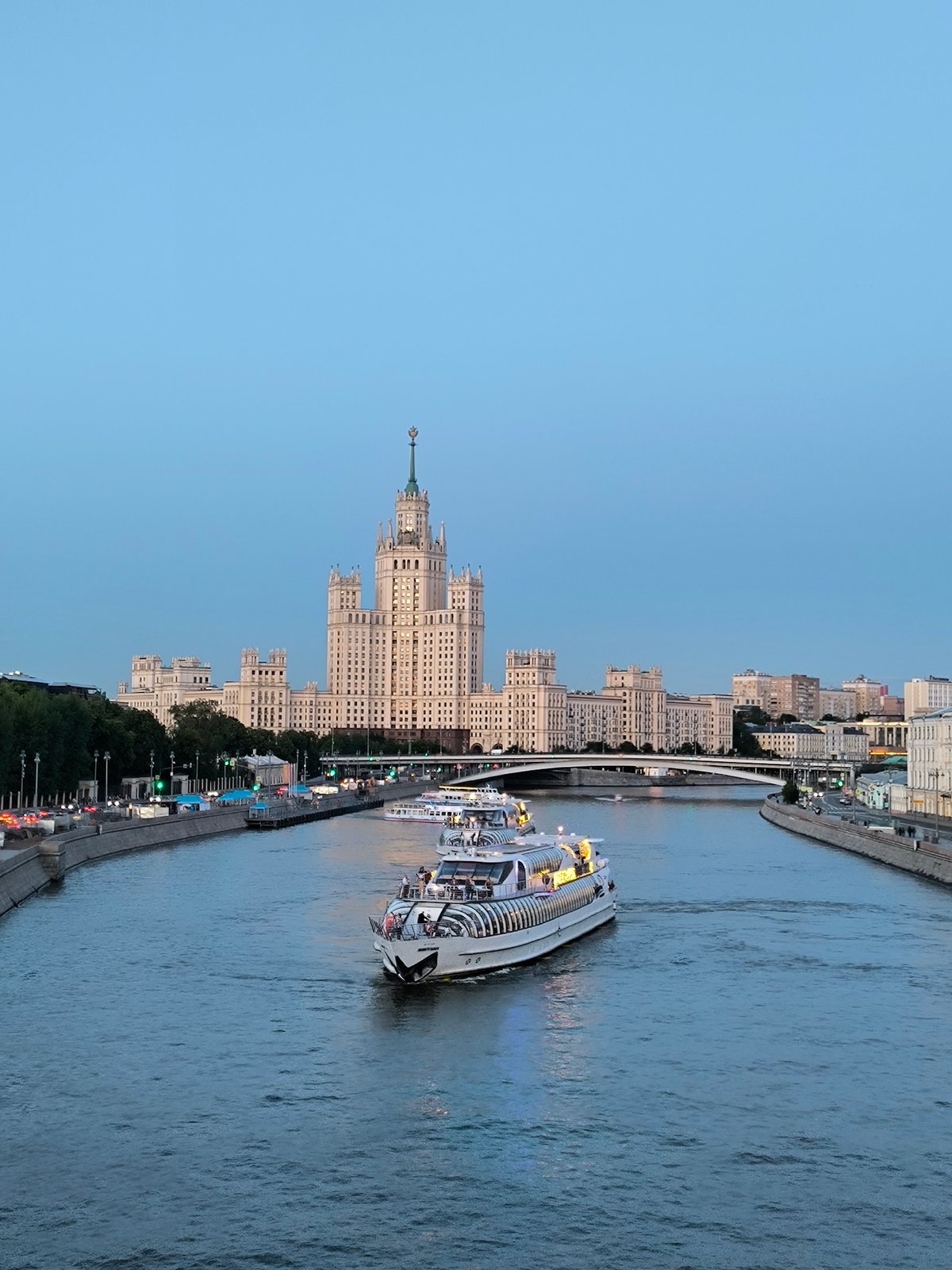 Moscow riverfront at dusk, fountains and city skyline