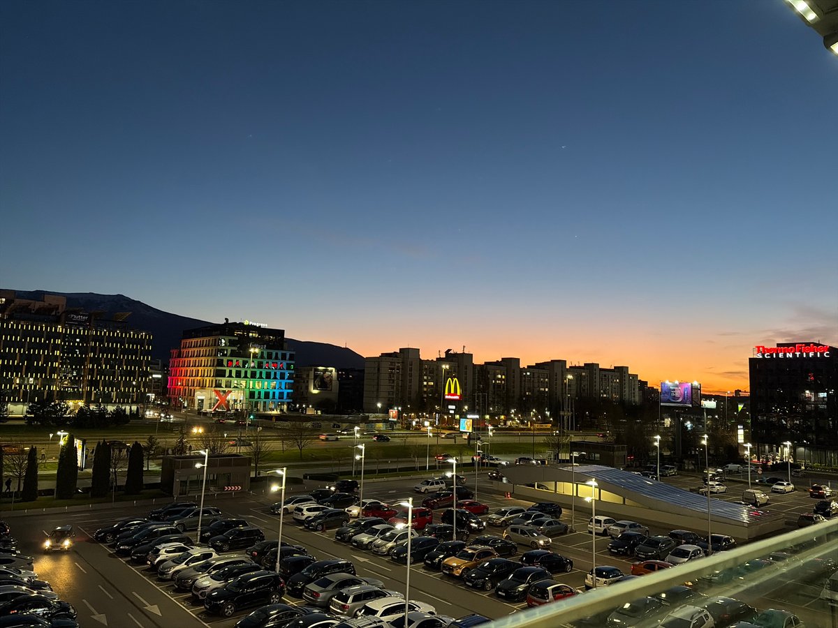 Evening parking garage view captures busy Sofia lot at dusk