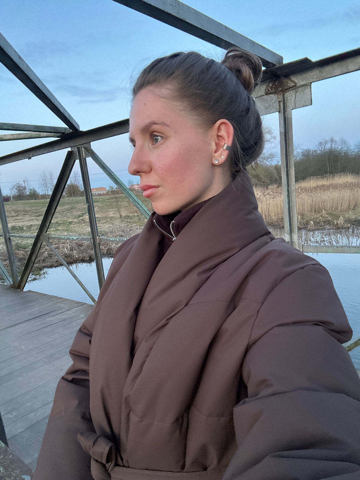 Couple films evening walk along waterfront in Klin, Russia