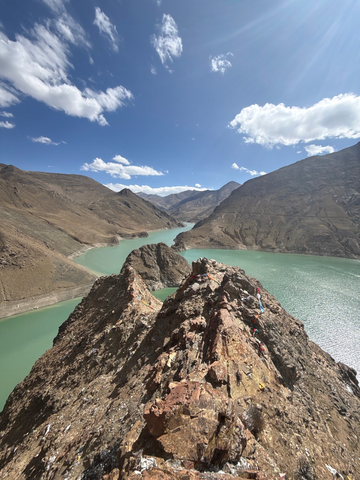 Hiker Documents Turquoise Mountain Lake Views in Tibet
