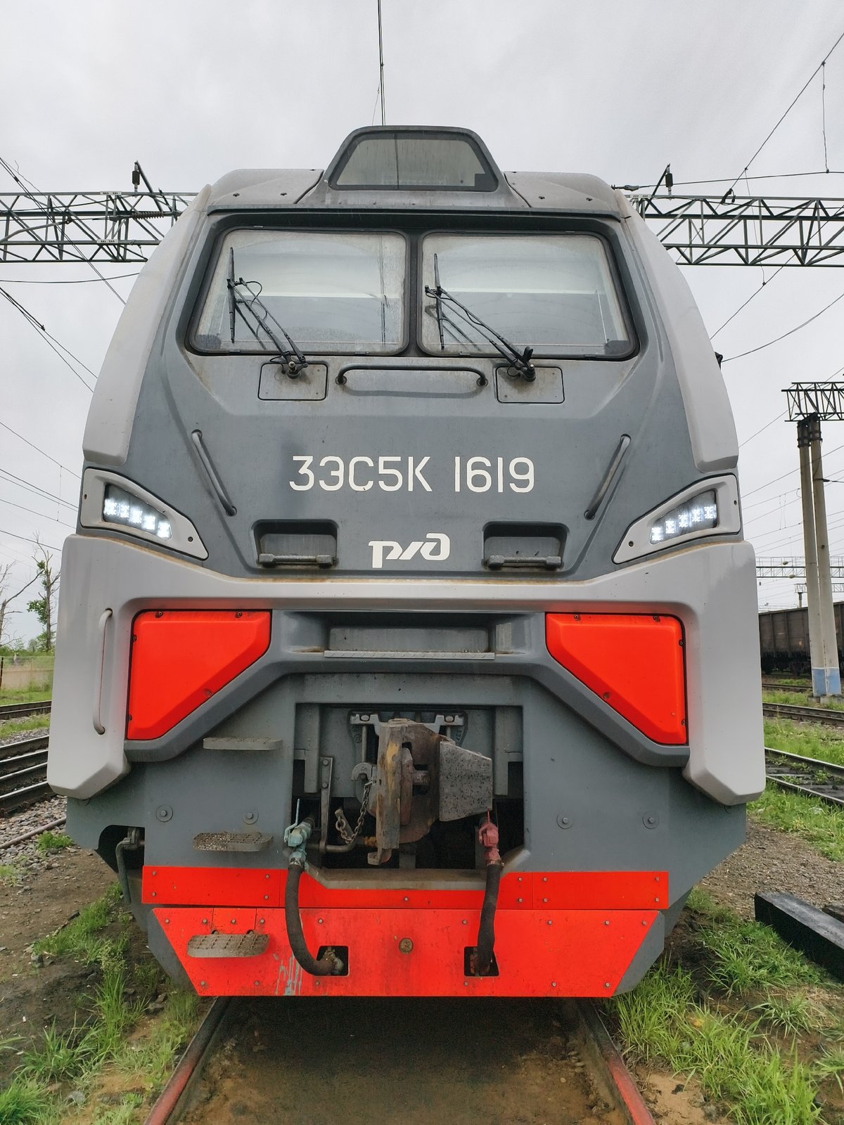 Rail worker documents train journey across metal bridge