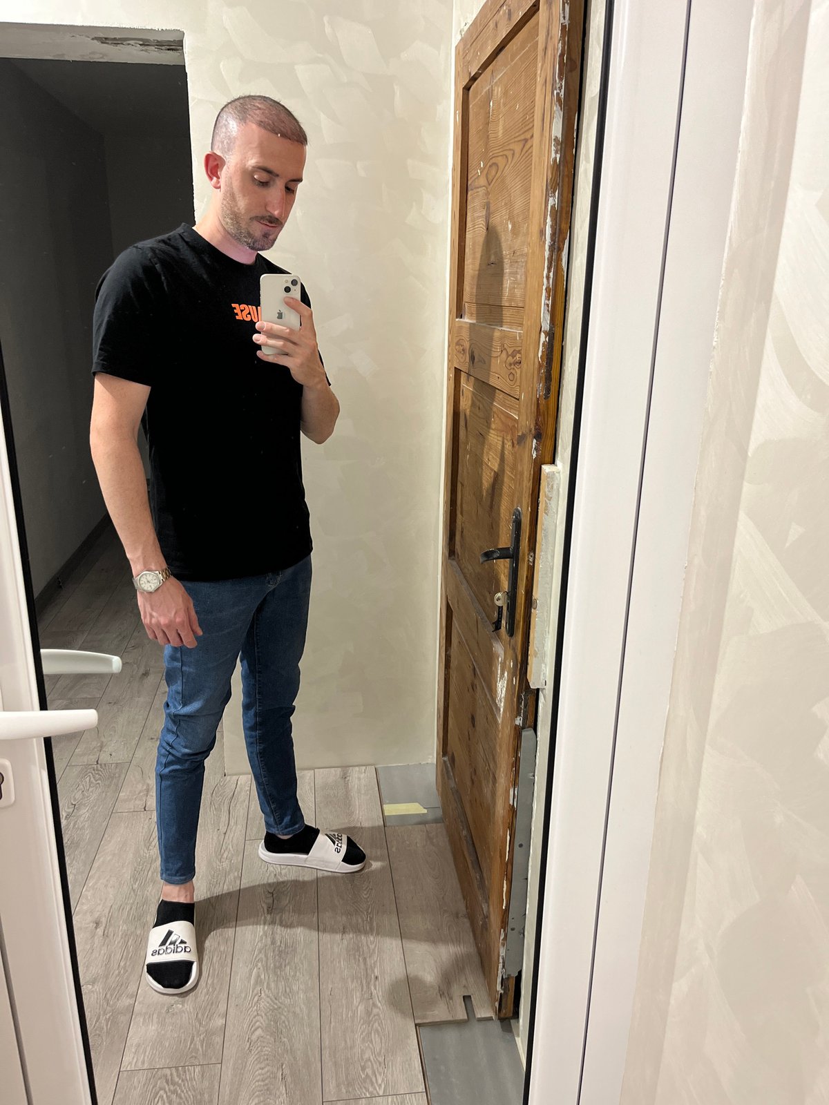 Man Takes Mirror Selfie in Chepintsi Hallway