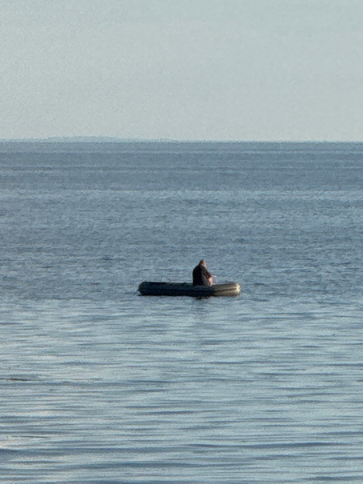 Floating in a dark inflatable dinghy on Russian coastal waters