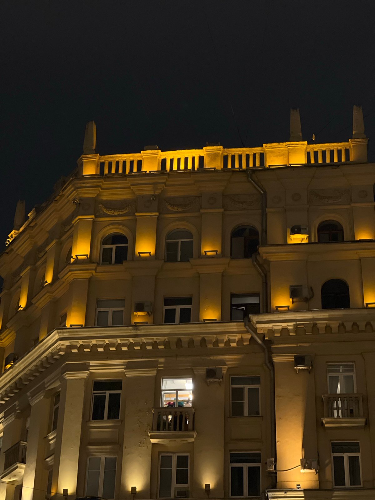 Nighttime architectural photography session captures illuminated Moscow building facade