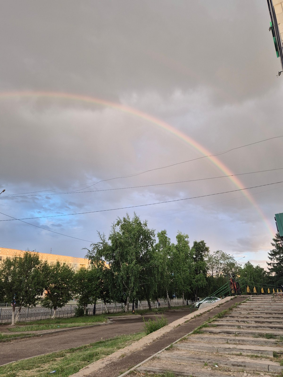 Double rainbow arcs over Kokshetau, Kazakhstan cityscape and mosque