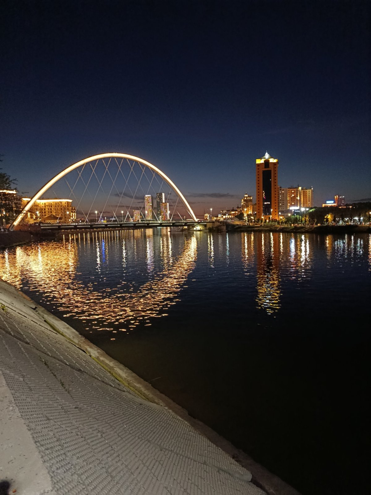 Nighttime stroll along Astana's Ishim River embankment
