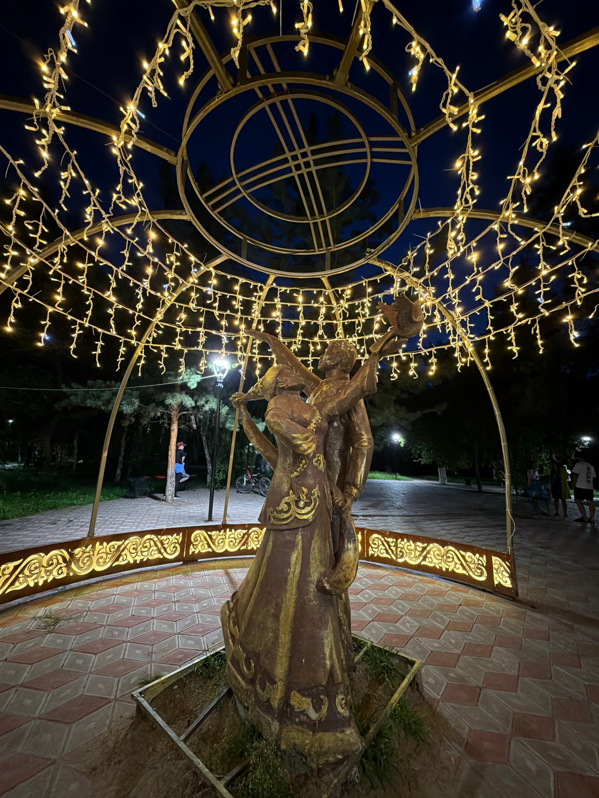 Pavlodar's romantic public art and nighttime streets.