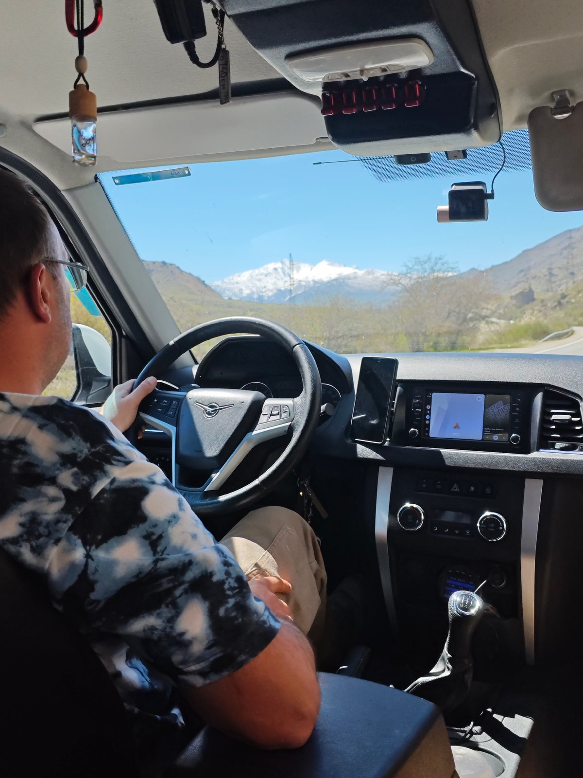Driver travels through mountainous landscape near Bedyk, Russia