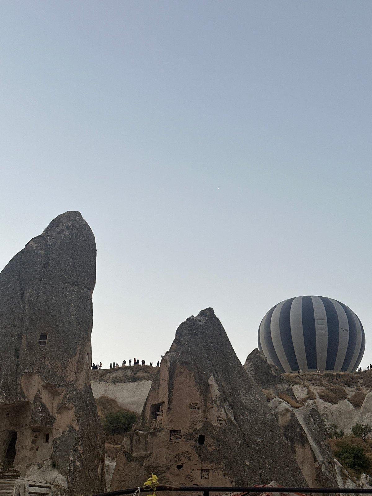 Hot air balloons rise over Göreme's rock formations at dawn