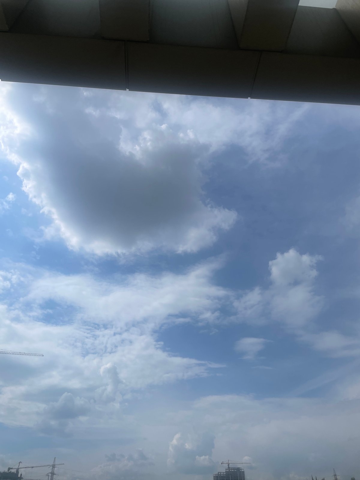 Construction activity documented across Yerevan skyline under partly cloudy skies