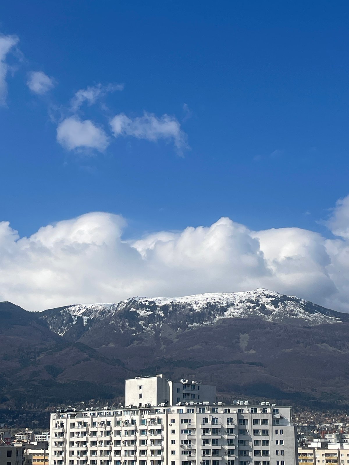 Aerial view captures Sofia's urban landscape against mountains