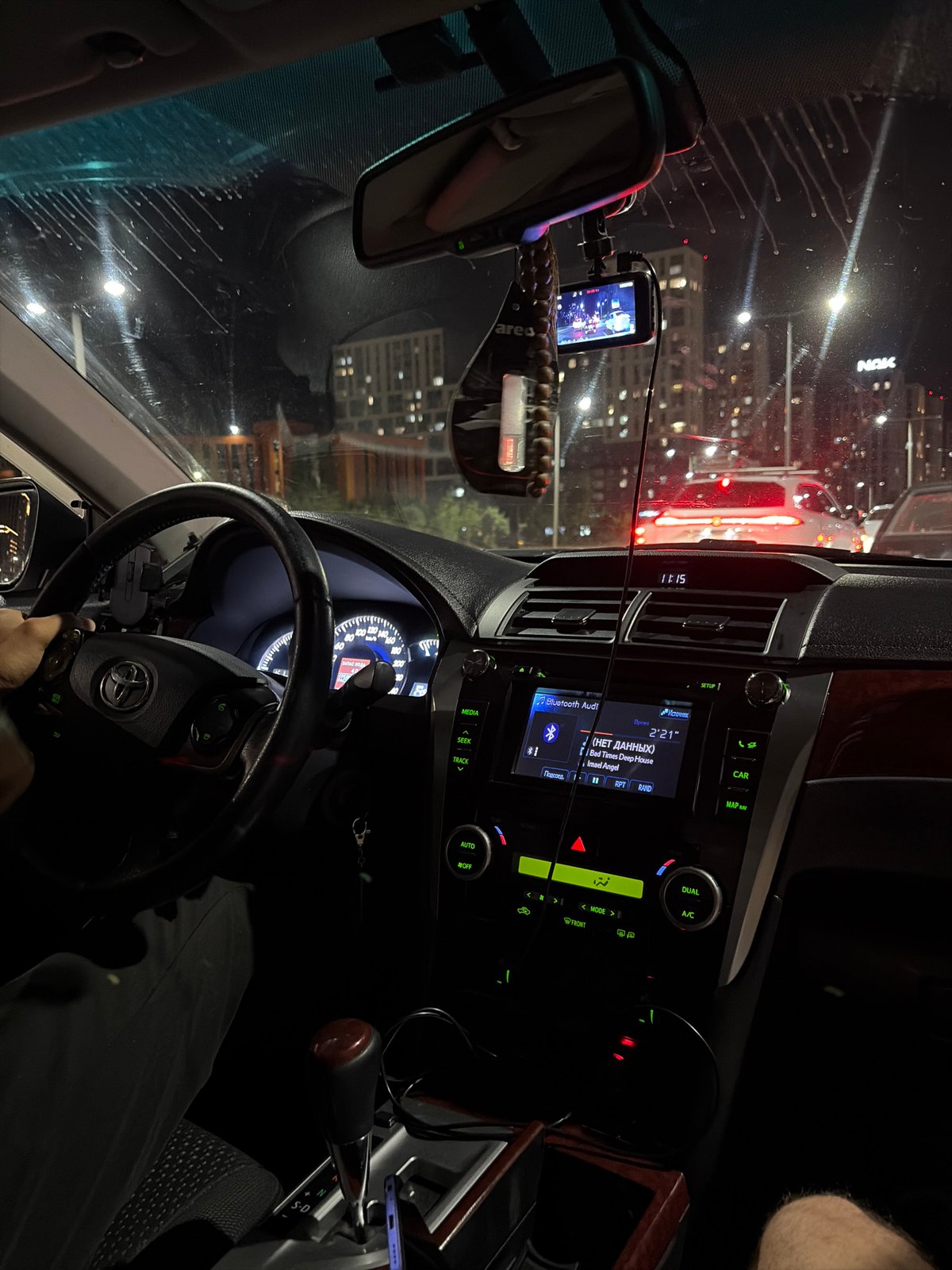 Nighttime moments in and around a parked white car.