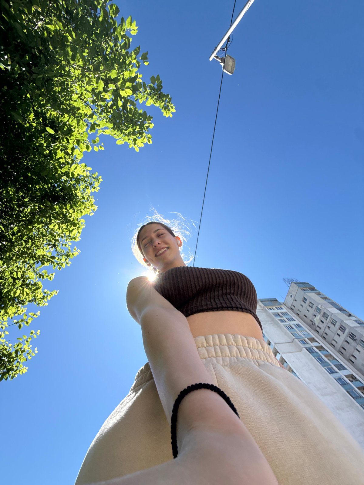 Woman walks dog while taking selfies in Sofia