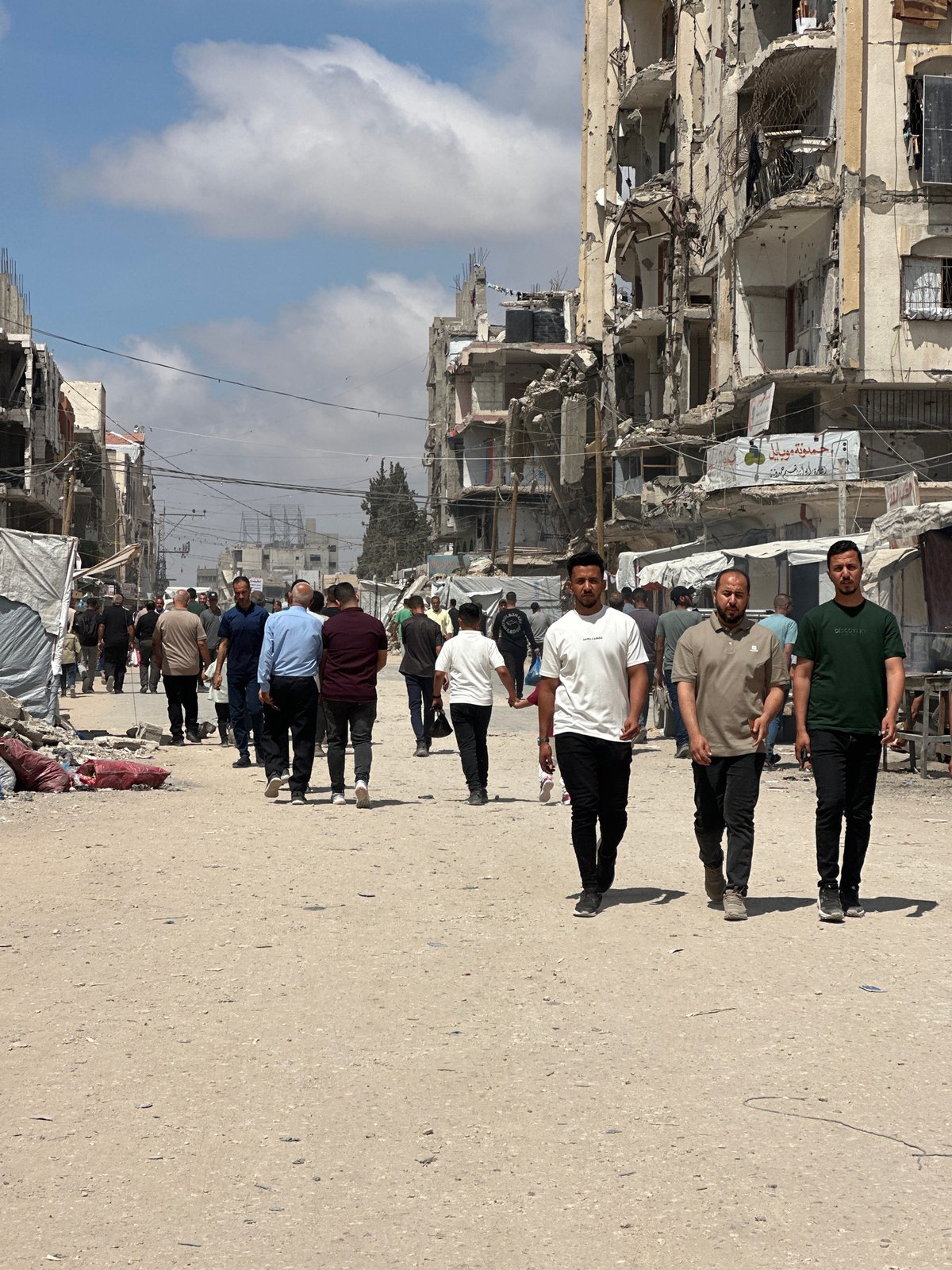 Men walk through war-damaged Gaza City street