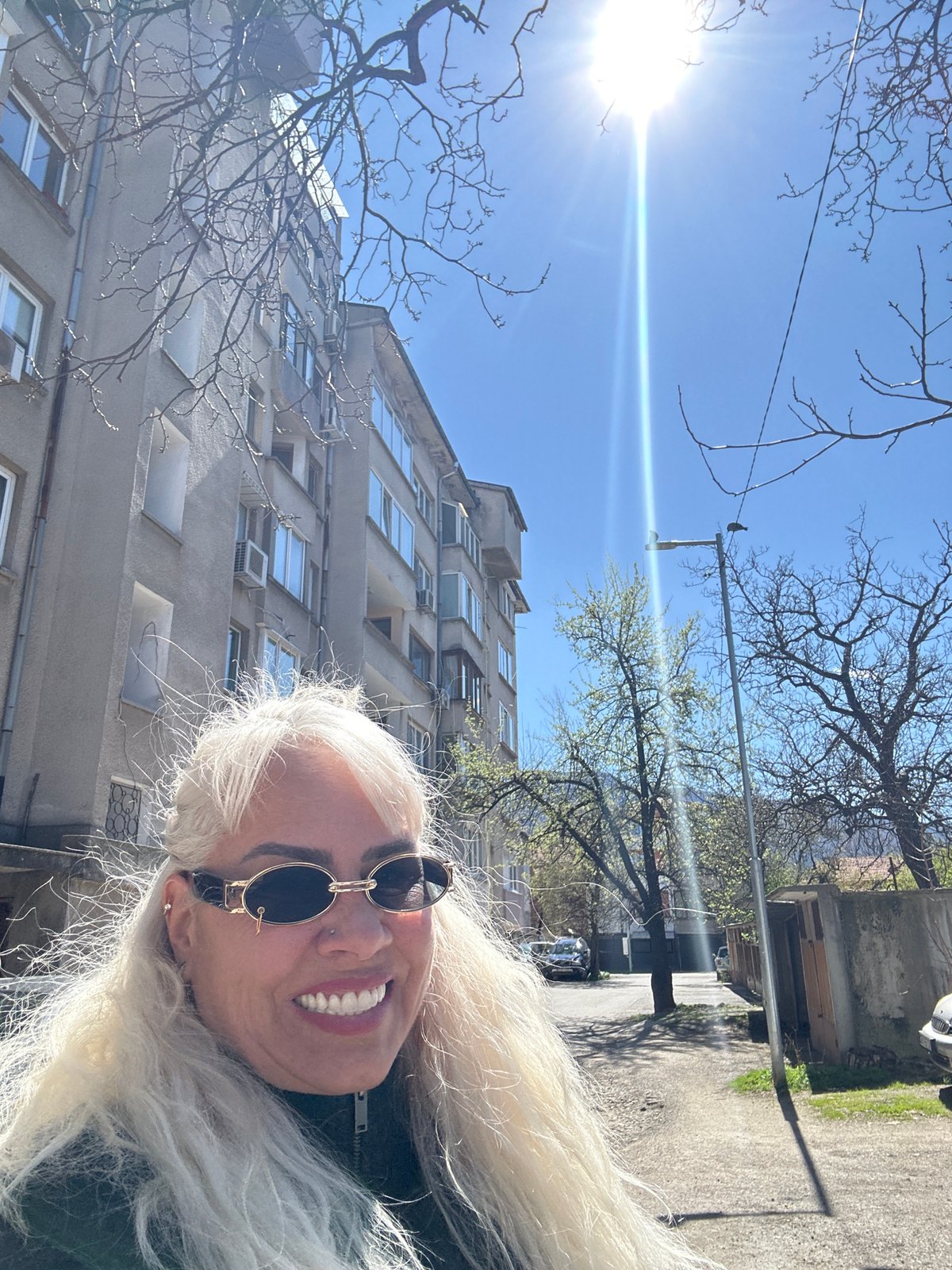 Woman photographed smiling outside residential building in Sofia