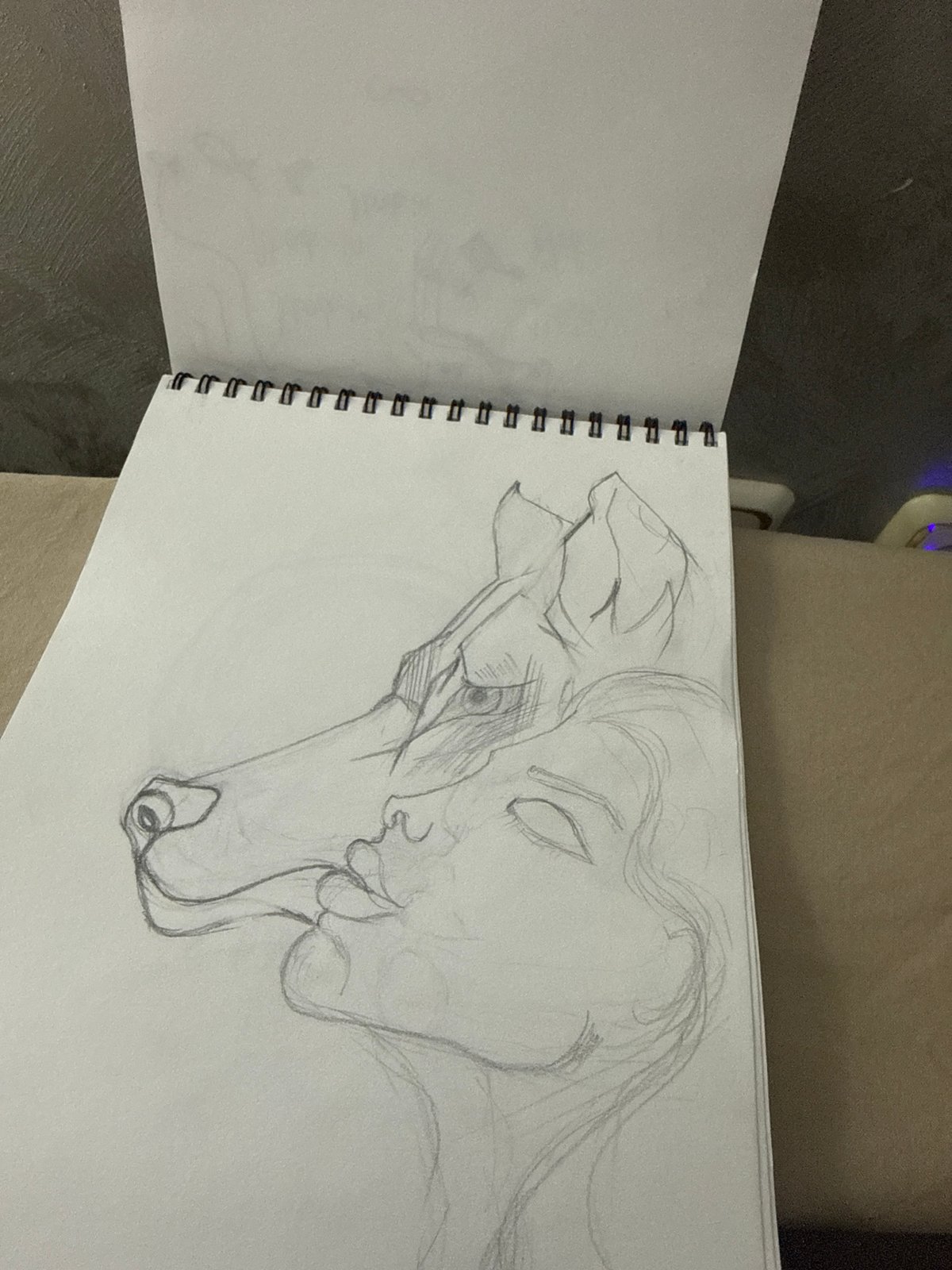 Artist sketches intimate human-dog embrace in Bulgarian sketchbook