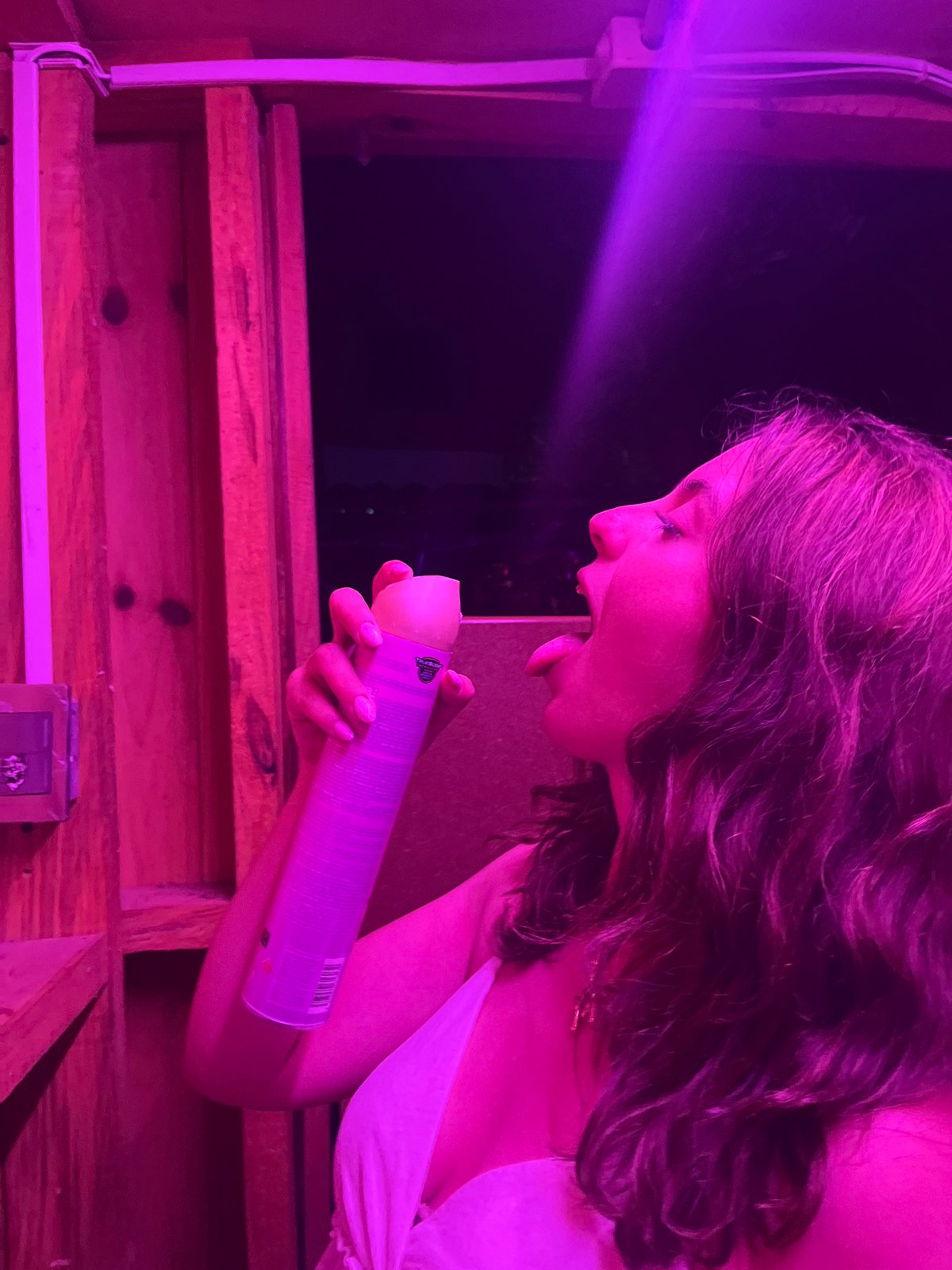 Young women take selfies in neon-lit venues in Mexico