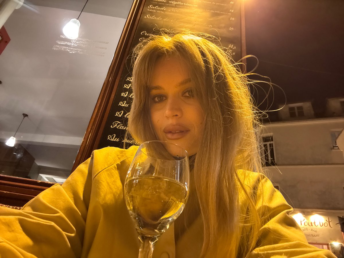 Woman enjoys wine at Parisian outdoor café