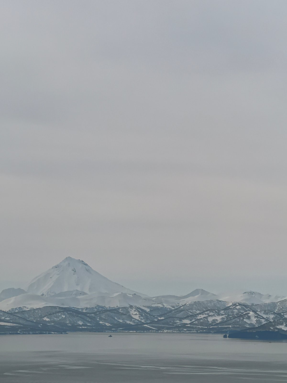 Snow-capped mountain landscape photographed with water foreground