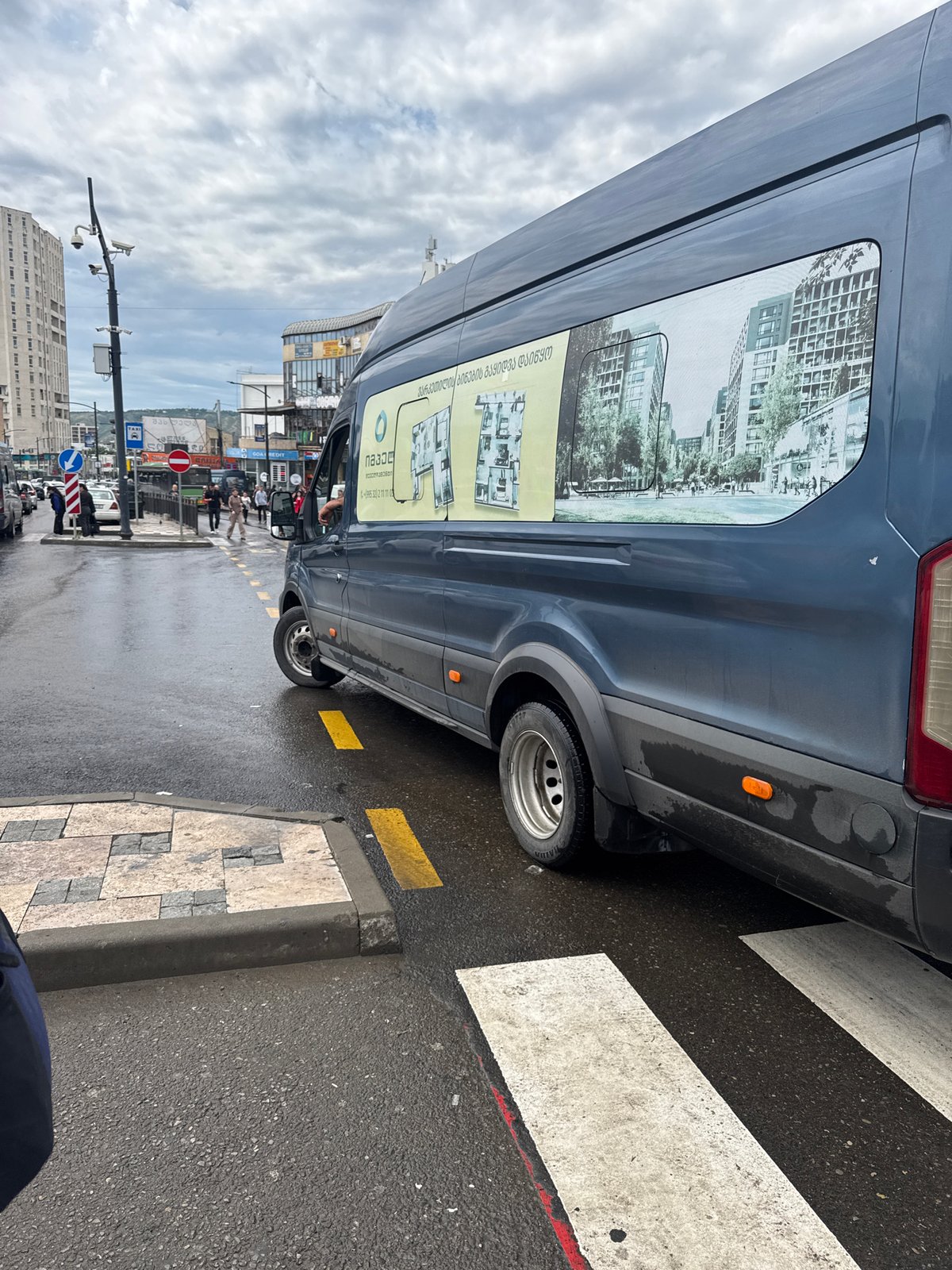 Morning street life documented across Tbilisi during overcast June day