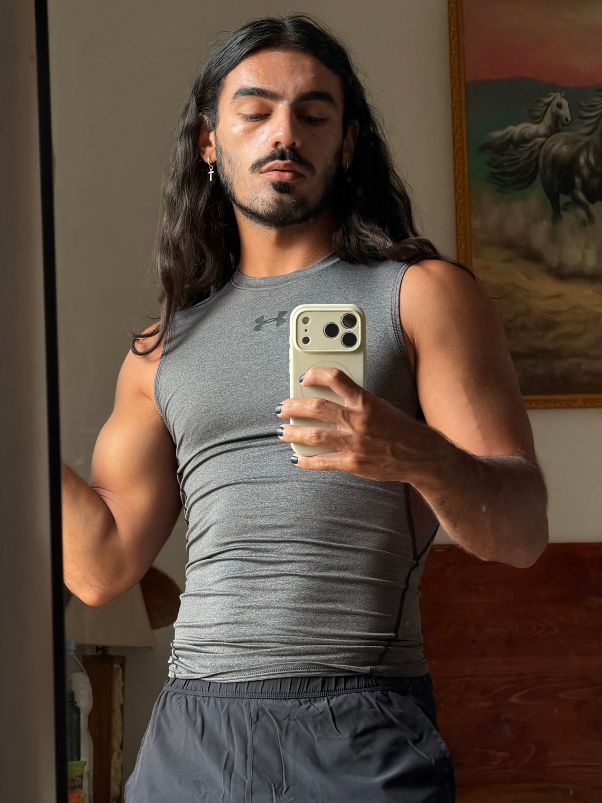 Man Takes Multiple Mirror Selfies in North Kuta Room