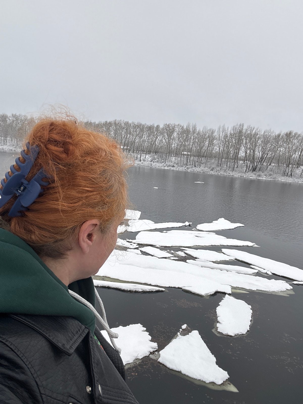 Winter documentation along frozen waterway in Chaikovsky, Russia