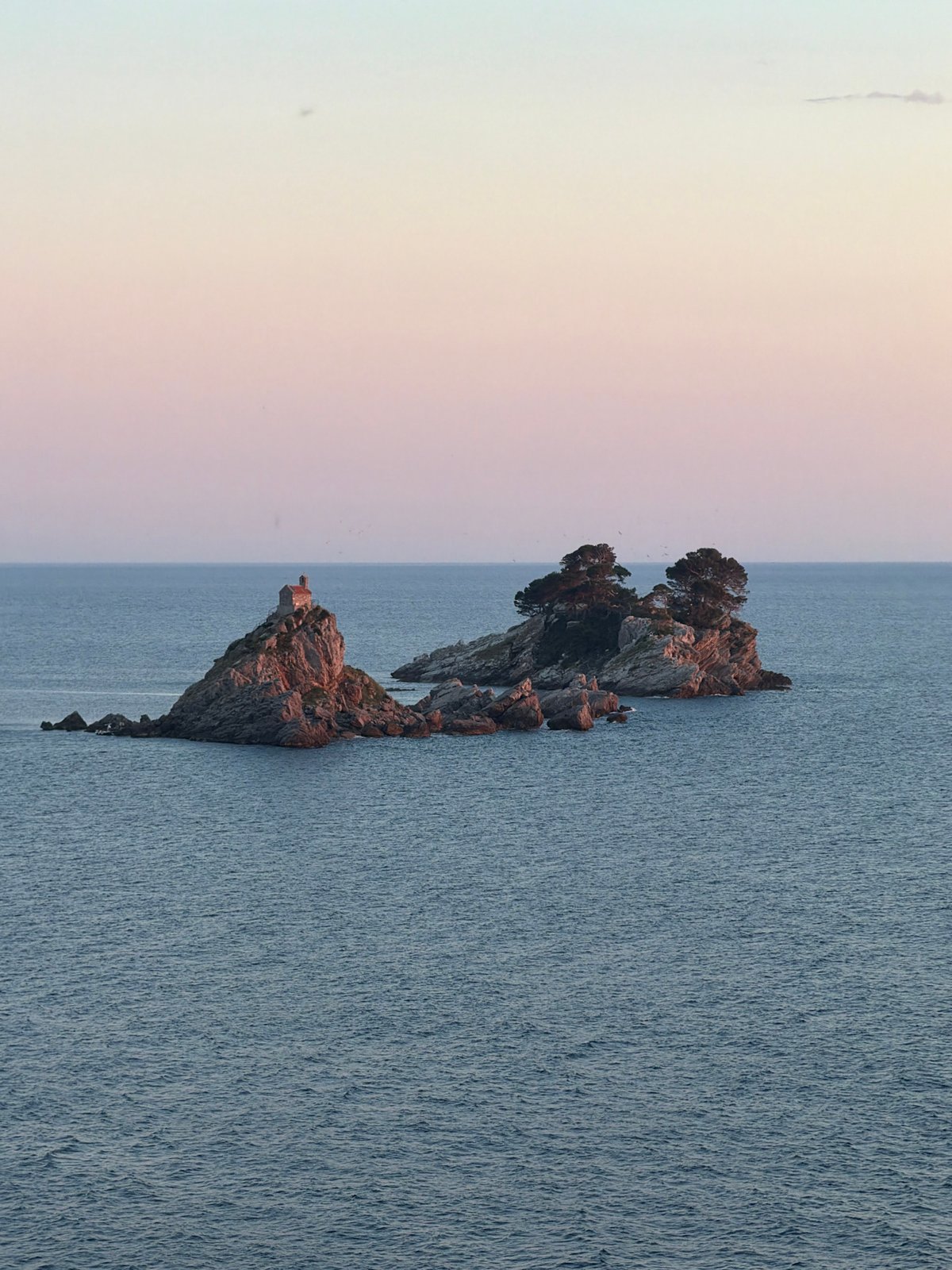 Rocky islet observed off Montenegro coast during evening hours