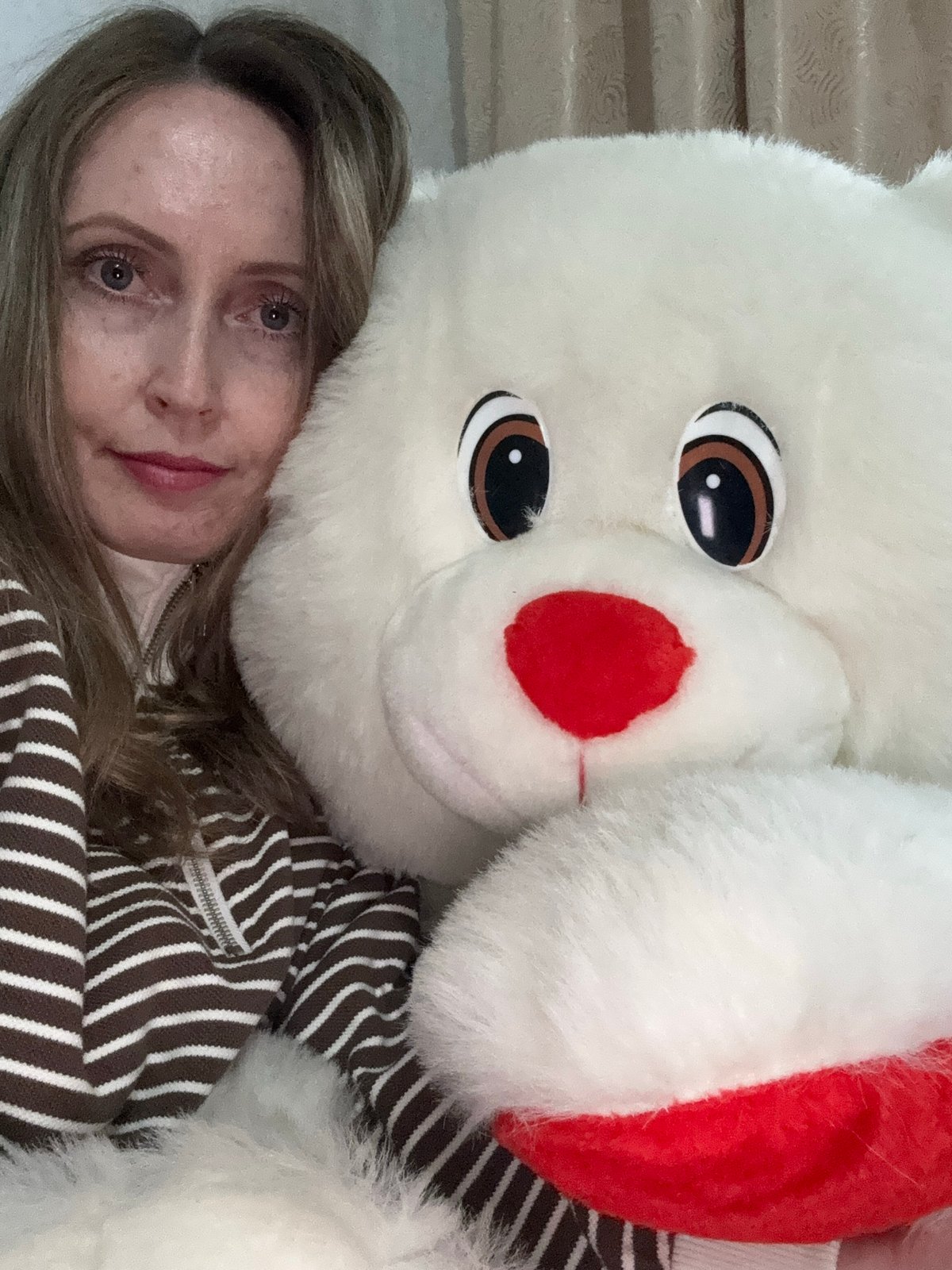 Woman takes selfies with plush toy and peonies in Russia