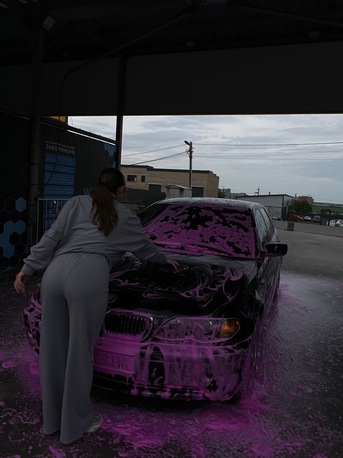 Woman washes BMW with pink foam at Ukrainian car wash