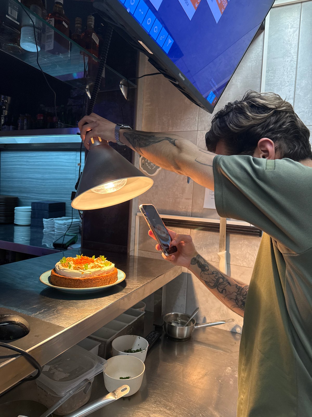 Restaurant kitchen activity and cake display in Budva