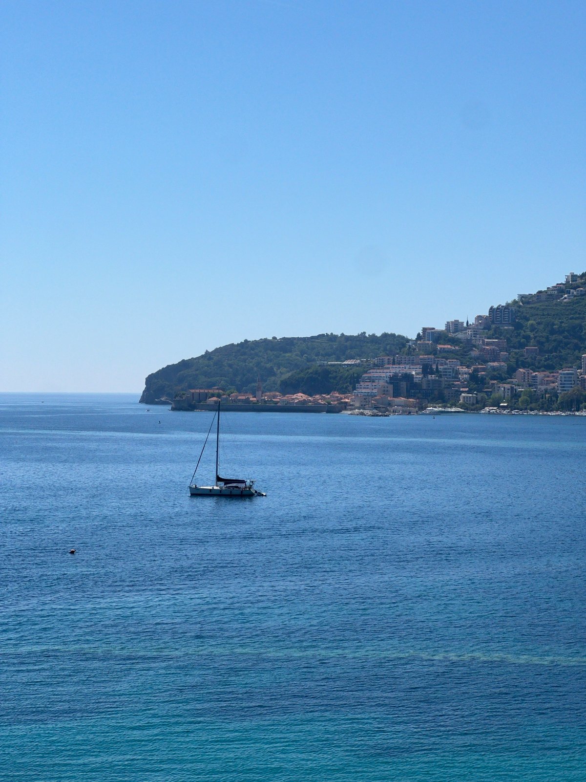 Clear skies frame tranquil Budva coastal scenes