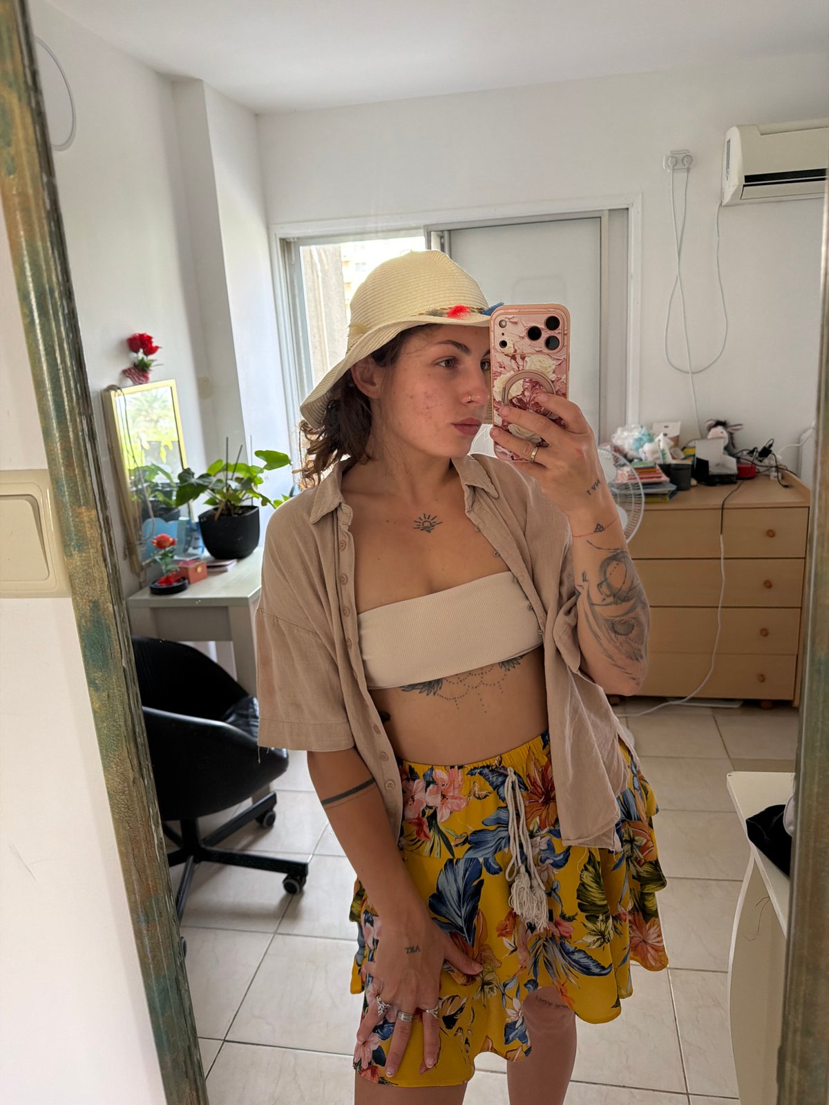 Woman takes mirror selfie in Kiryat Bialik wearing summer outfit