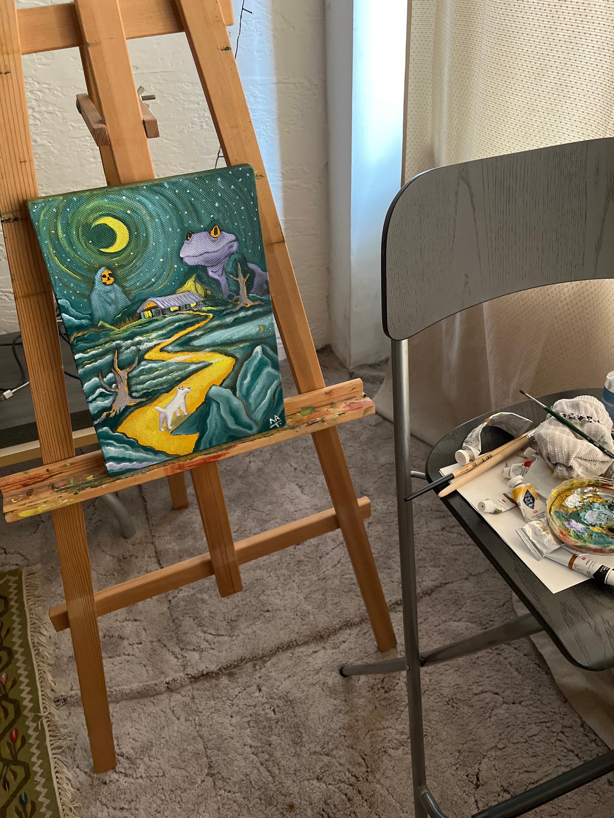 Artist workspace captures mystical landscape painting with glowing elements