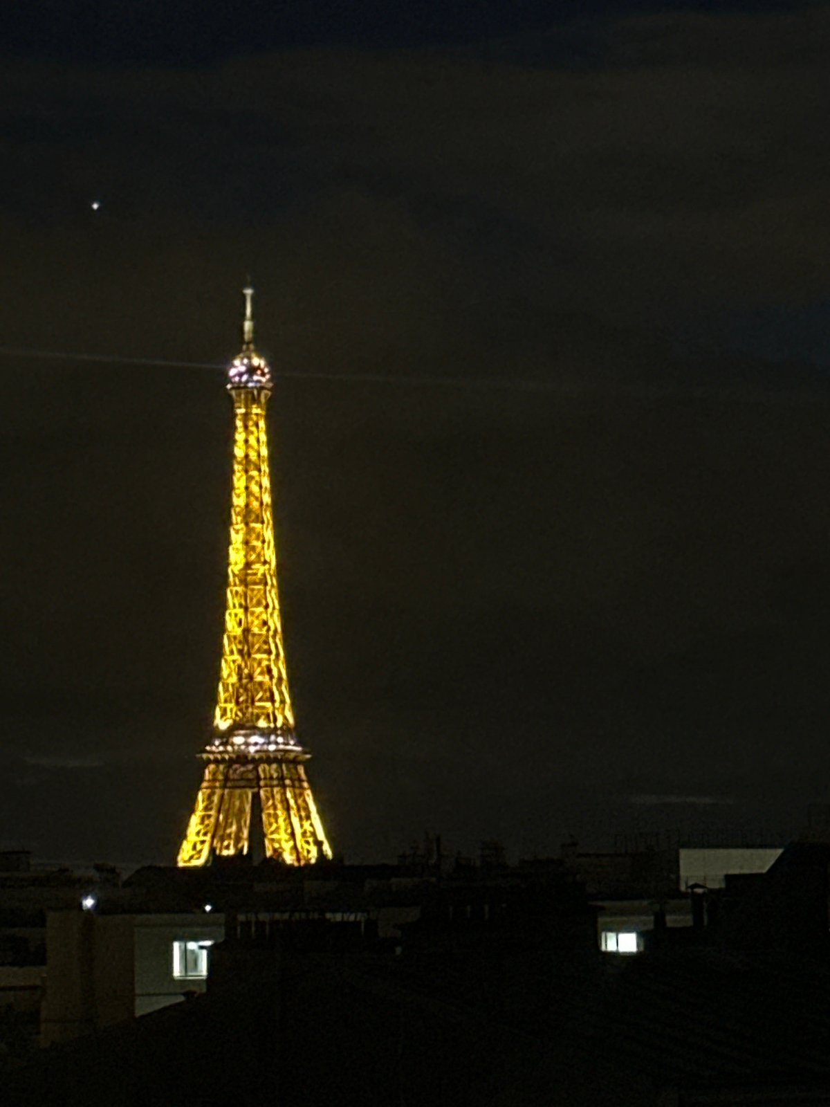 Eiffel Tower illumination captured across Paris nighttime skyline