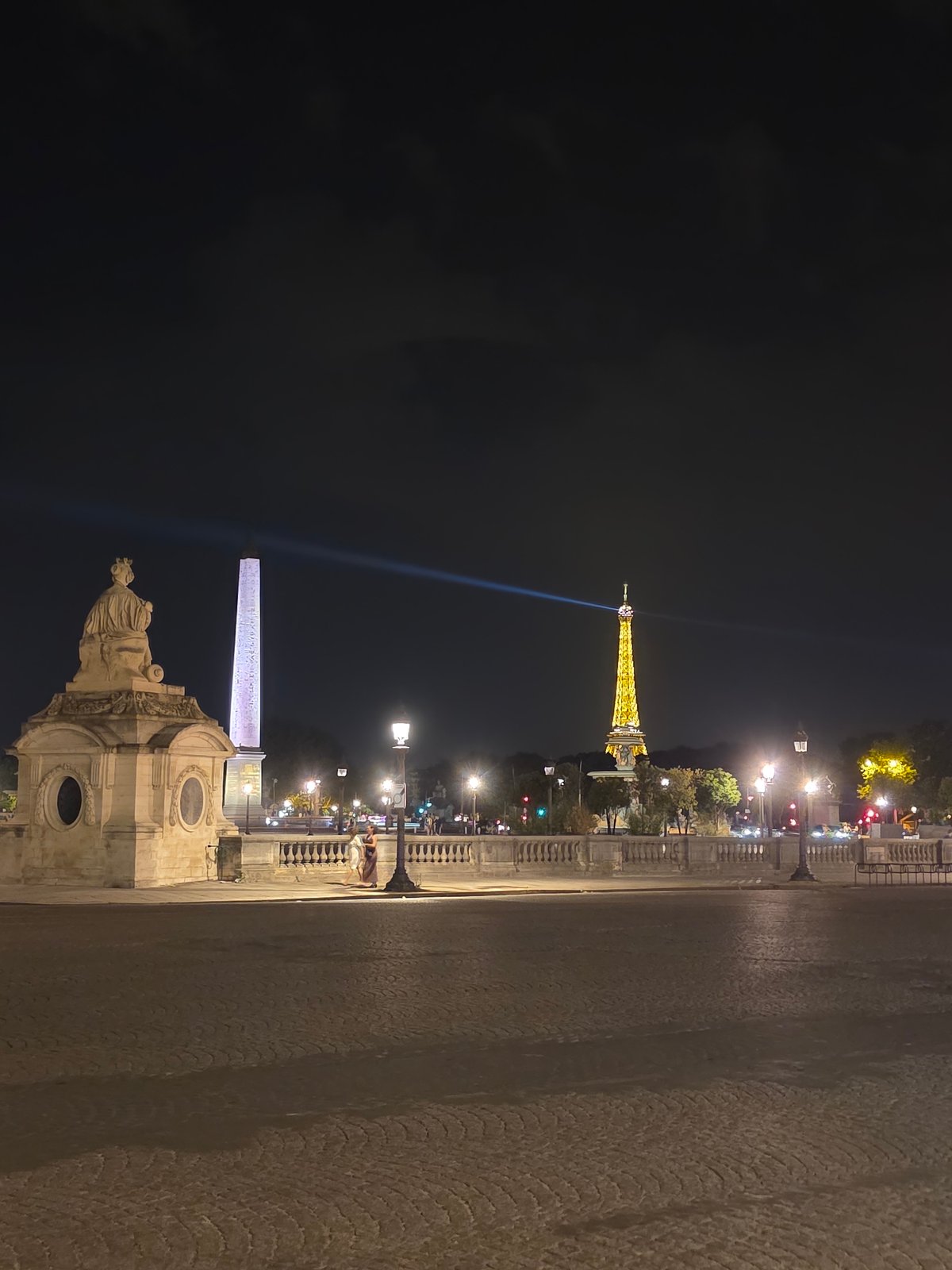 Three iconic Paris landmarks glowing on a June night