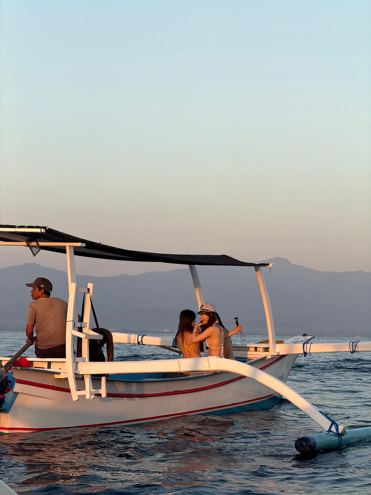 Sunset boat activity on Indonesian coastal waters