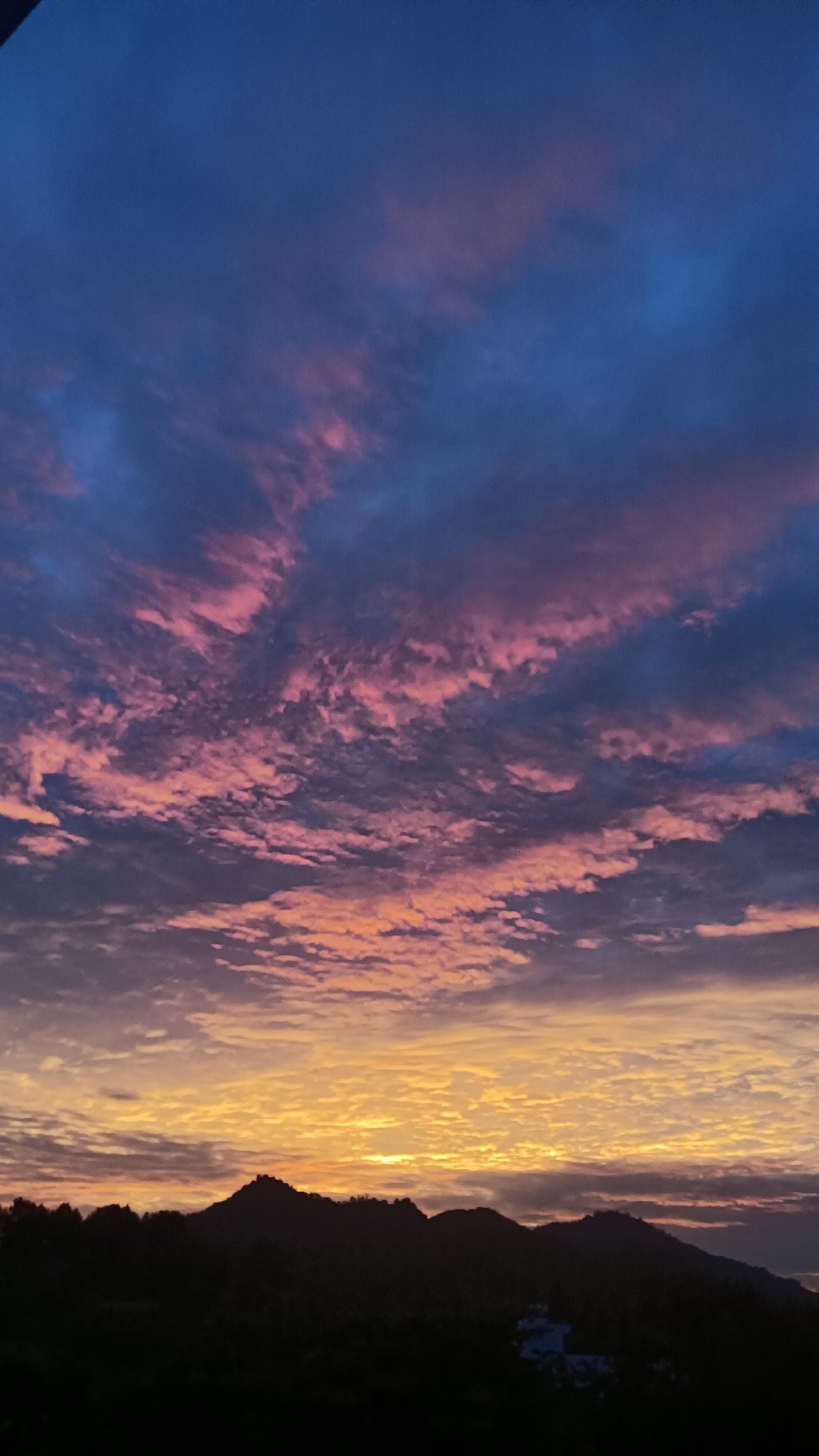 Rooftop sunset watch over Nha Trang's mountain skyline
