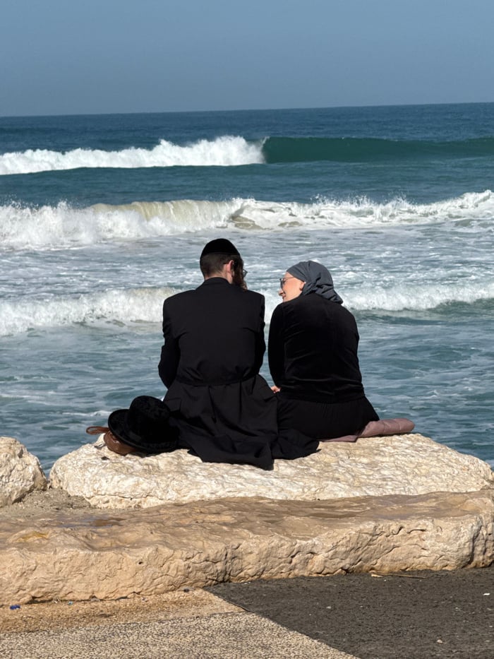 Surfers and beachgoers active along Tel Aviv Mediterranean coast