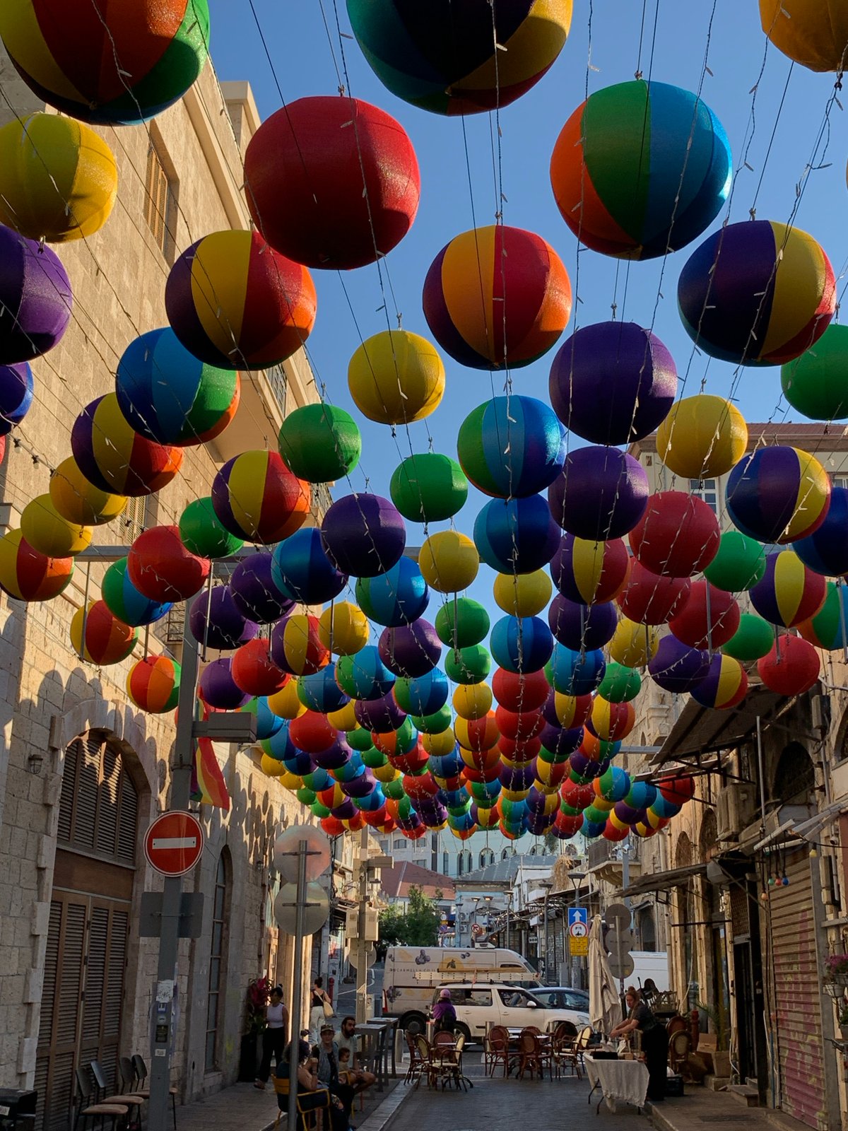 Lantern-lit Tel Aviv street with quirky outdoor lounge setup