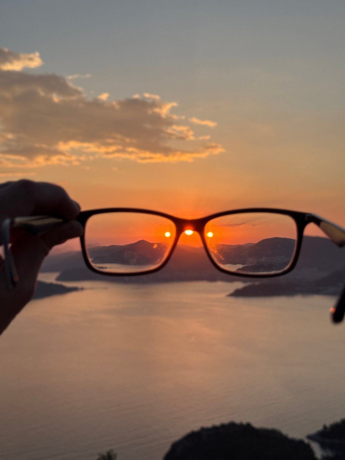 Sunset documented through creative framing at Sveti Stefan, Montenegro
