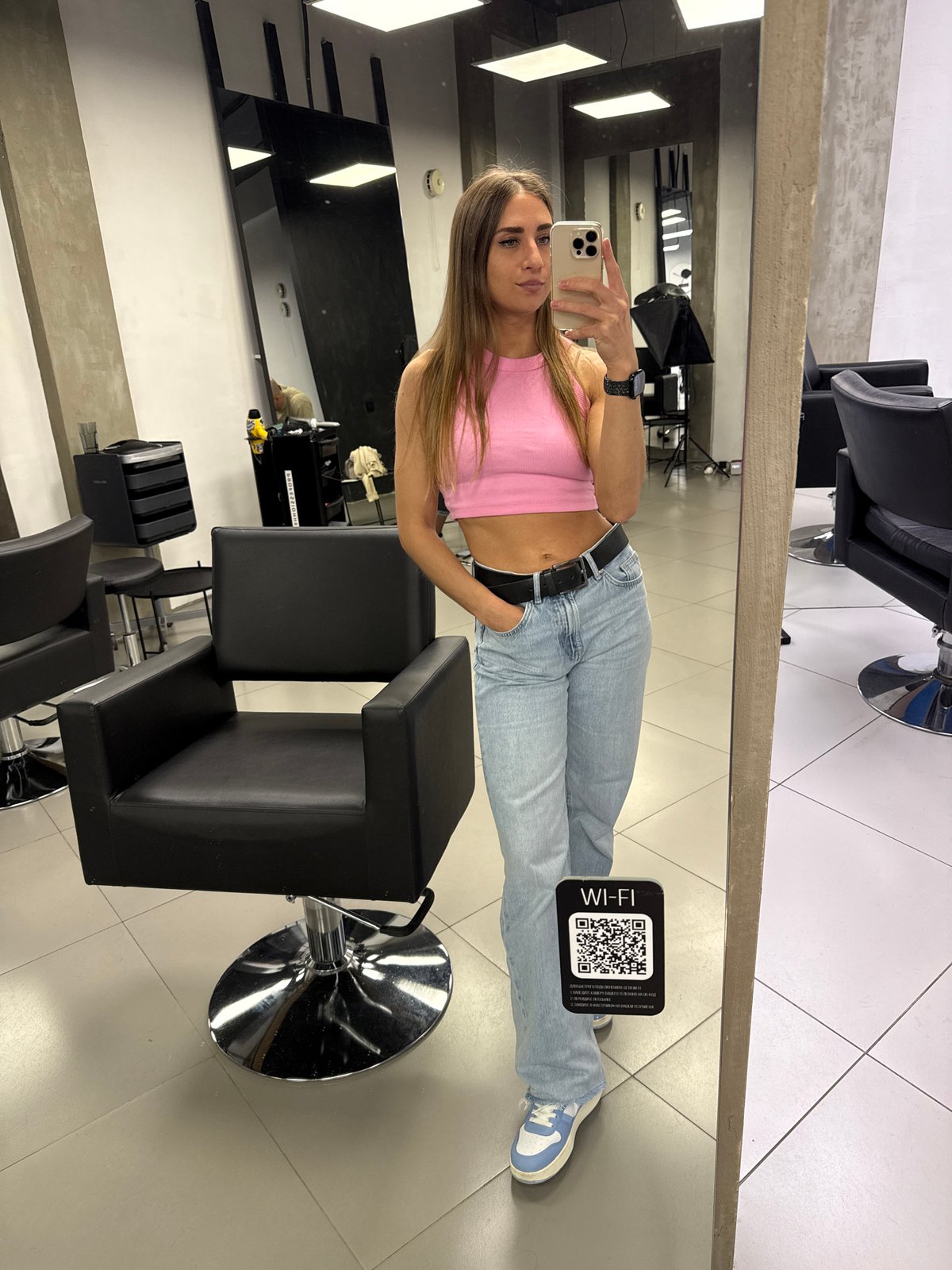 Woman takes mirror selfies at Saint Petersburg hair salon