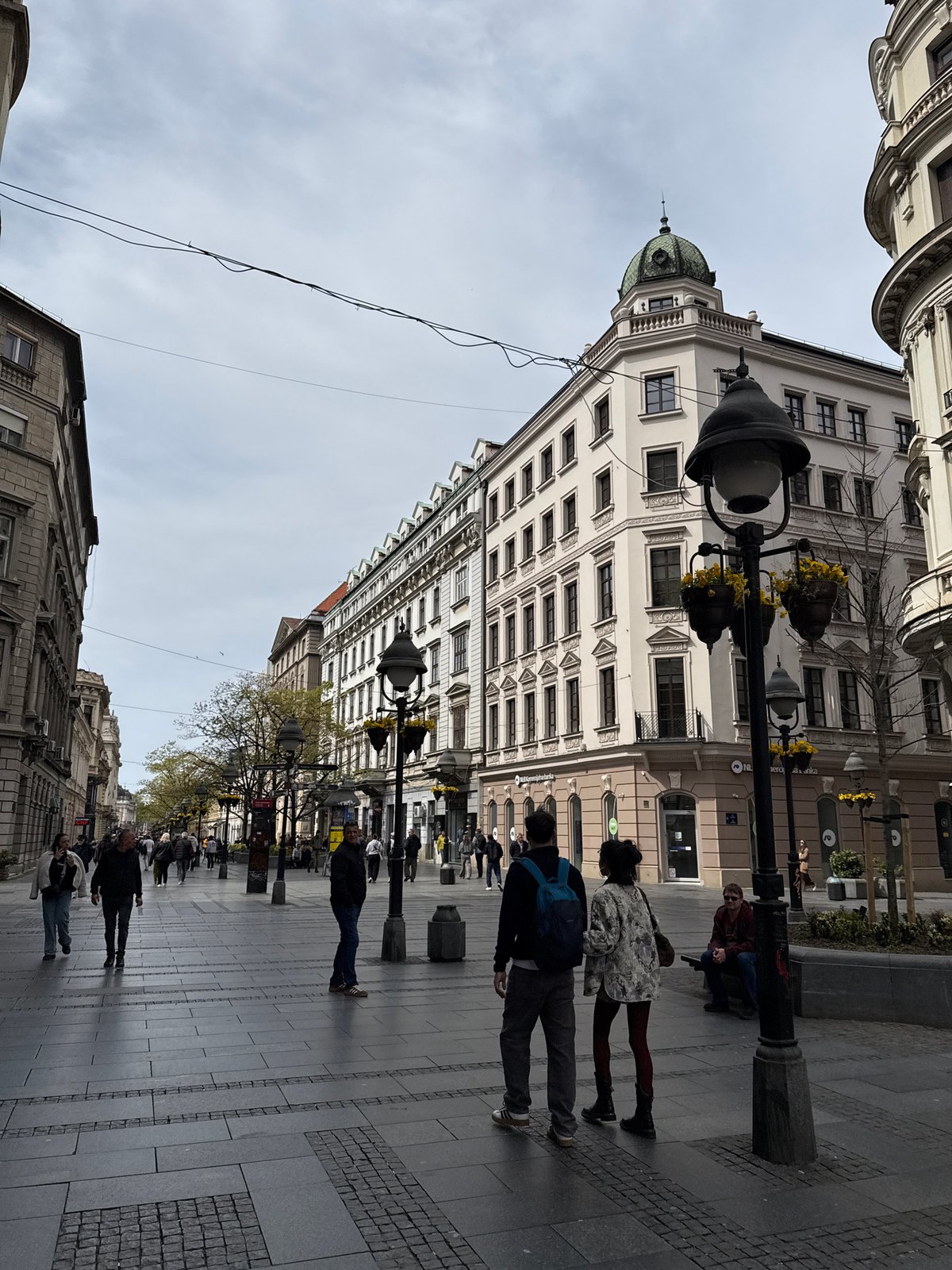 Street scene captured on Belgrade's Knez Mihailova featuring green-domed building