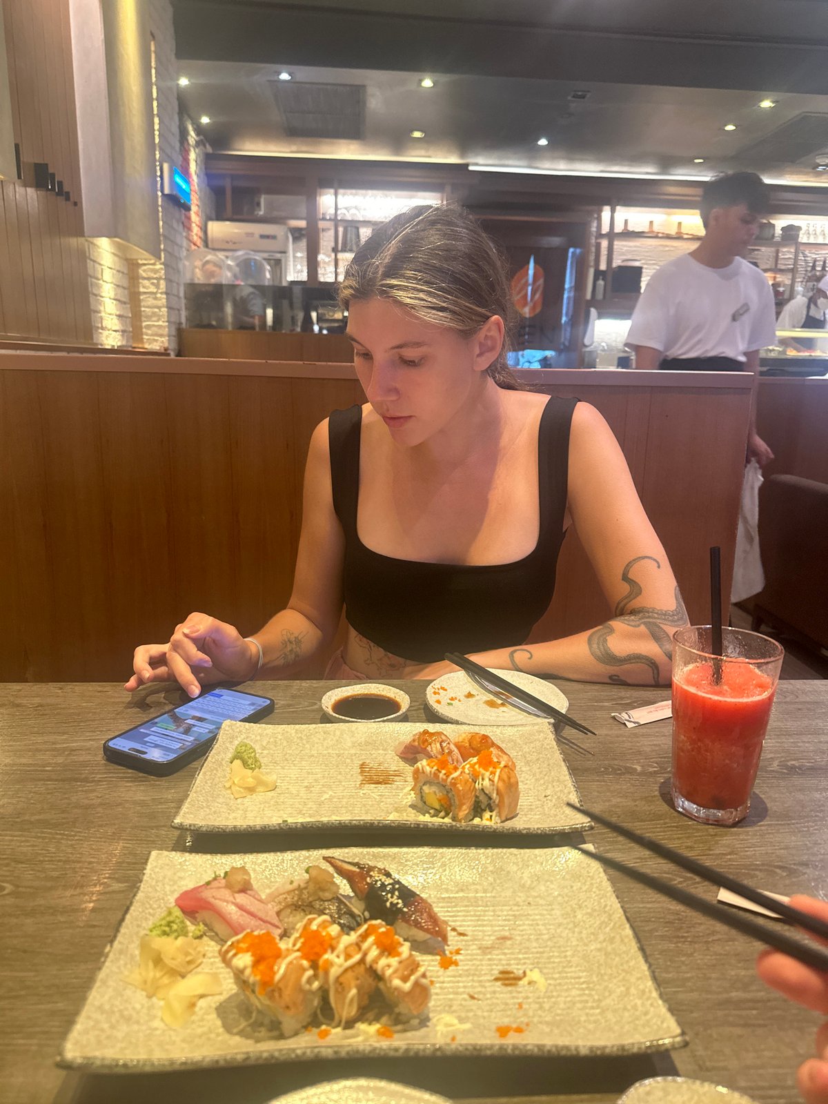 Woman enjoys sushi lunch at Thai restaurant