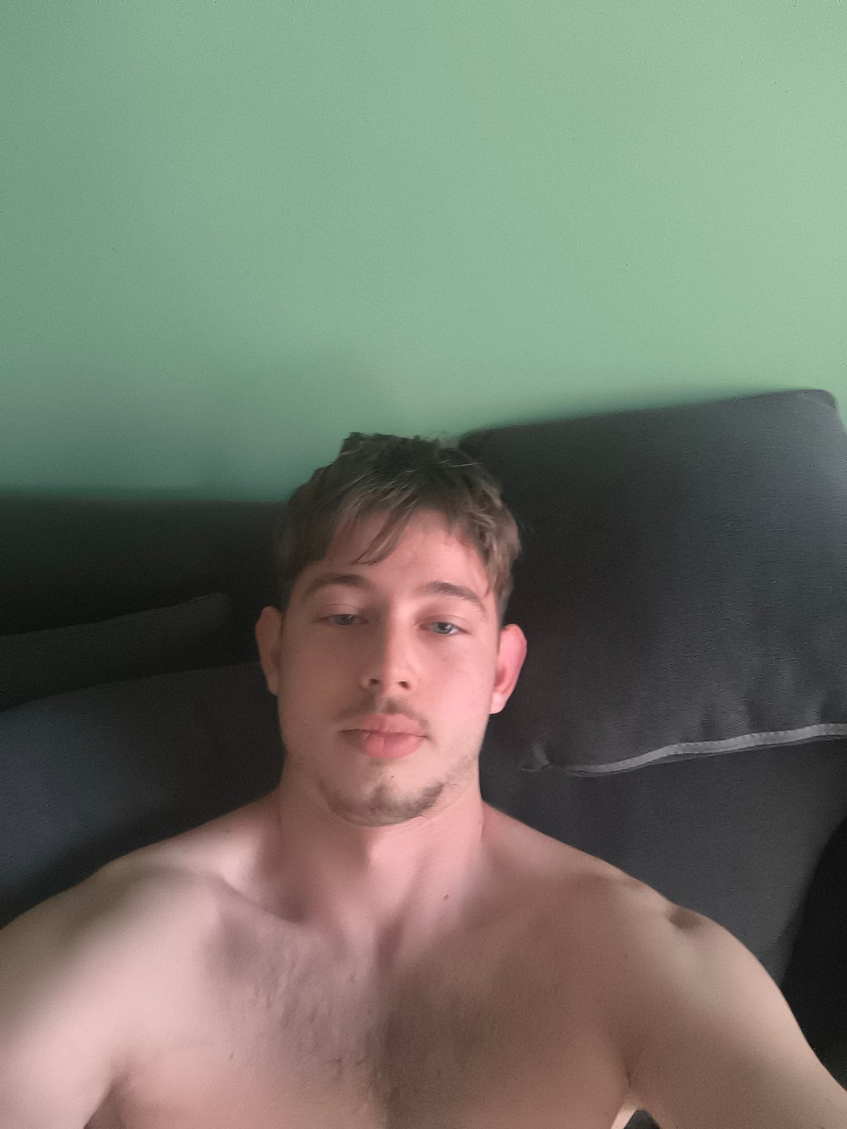 Young man takes selfies indoors in Sofia, Bulgaria