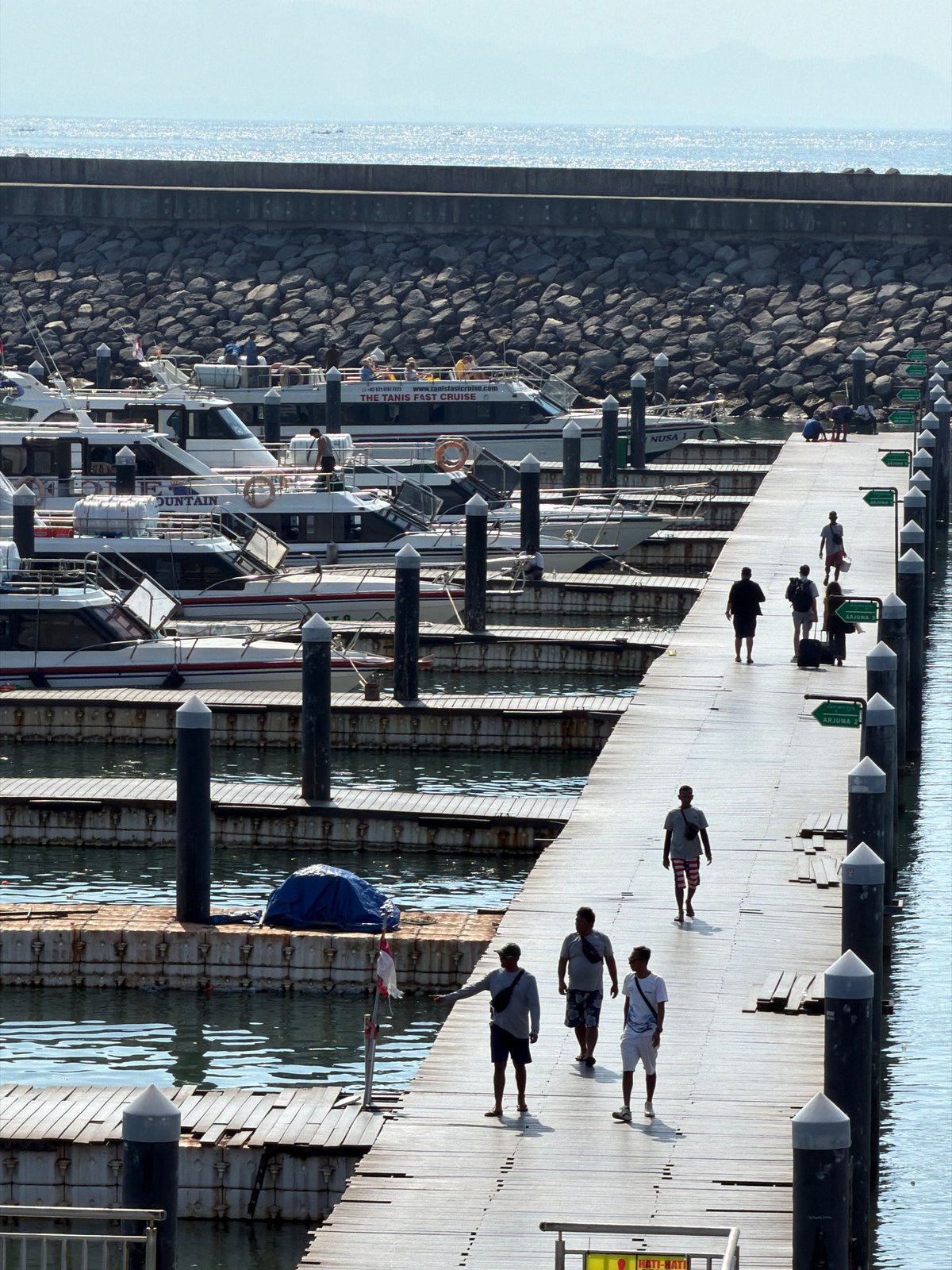 Morning scenes documented across Denpasar: pier, market, cafe, statue