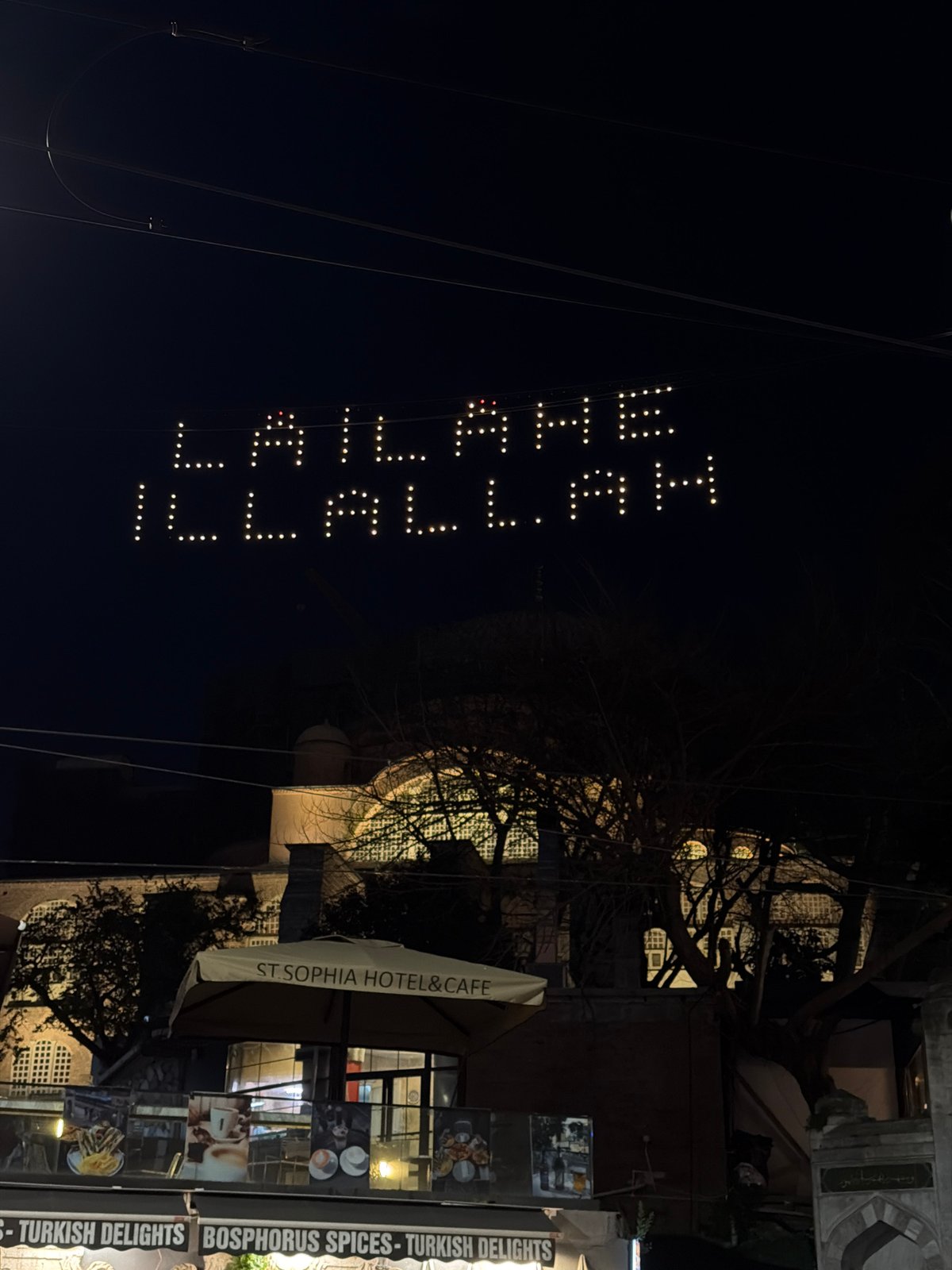 Arabic religious text illuminated on Istanbul street display