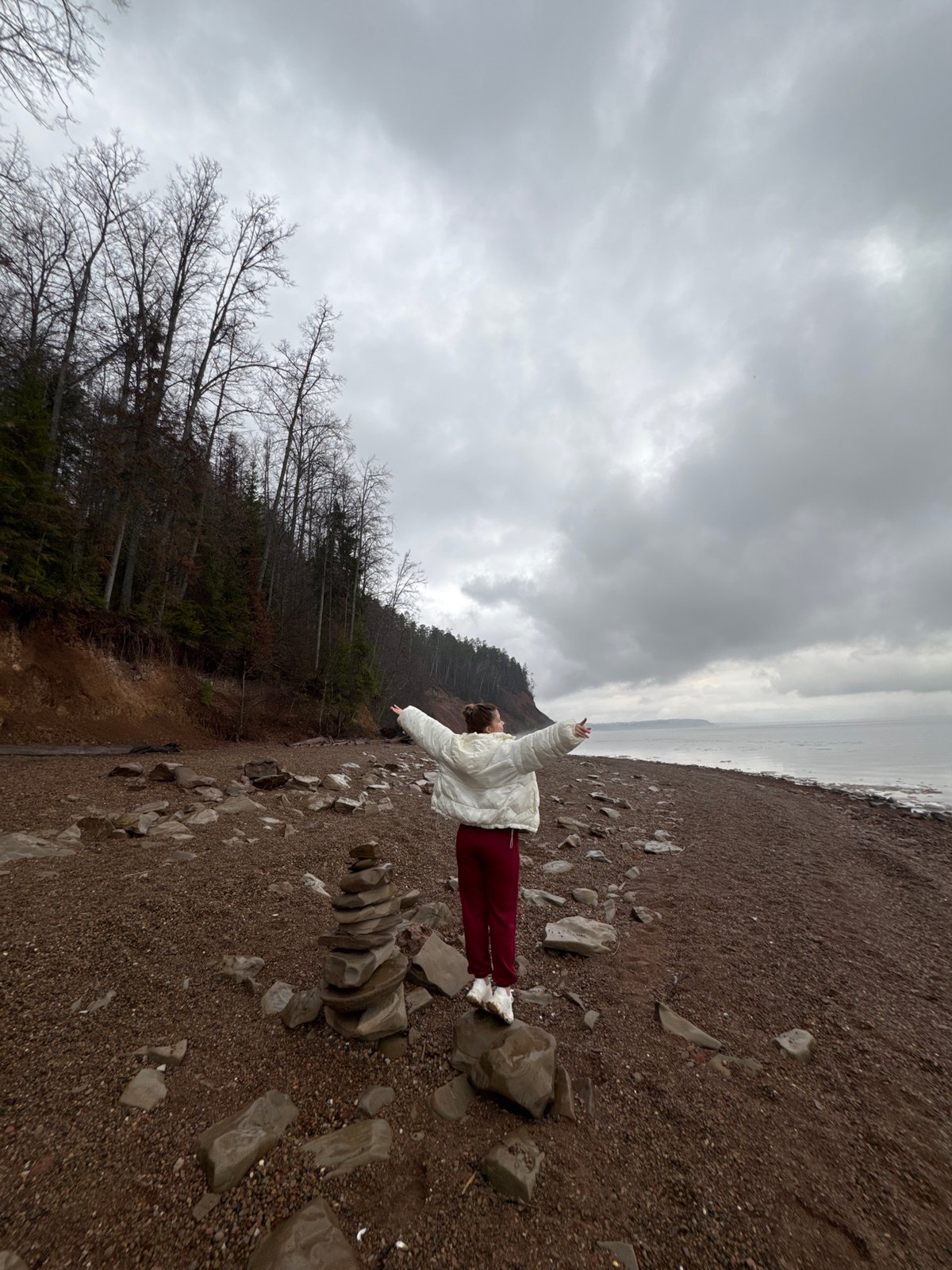 Person spotted on Russian pebble beach under overcast skies