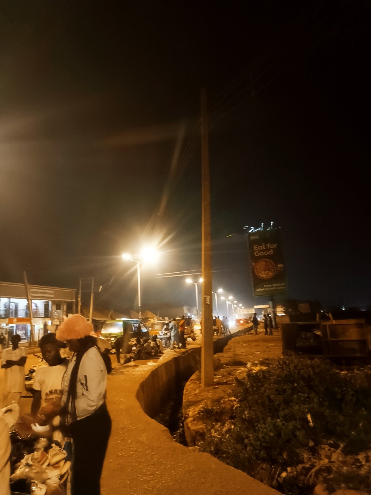 Evening street market bustles with vendors in Bukuru, Nigeria
