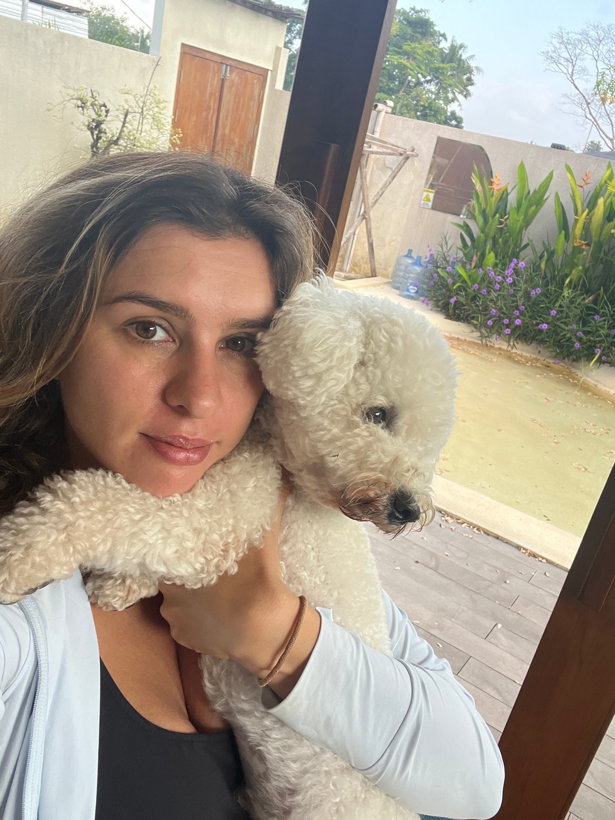 Lazy resort day in Kediri with a fluffy white dog