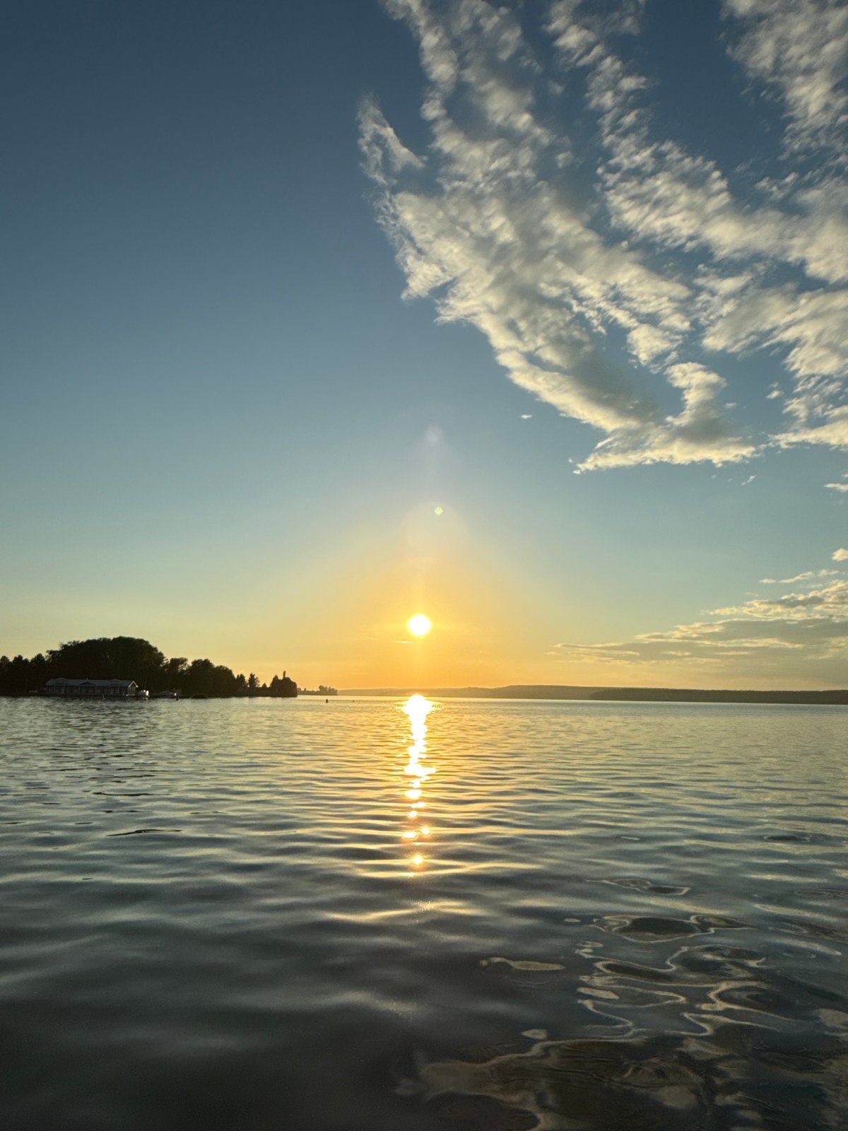 Votkinsk at golden hour: water, churches, and city skyline